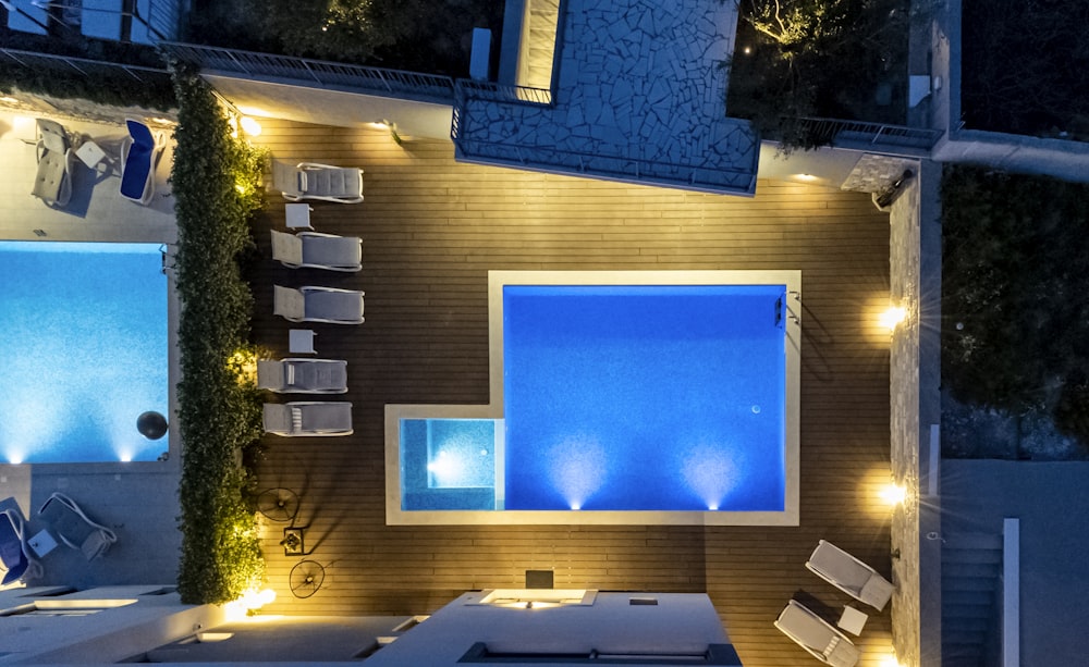 an aerial view of a pool and patio at night