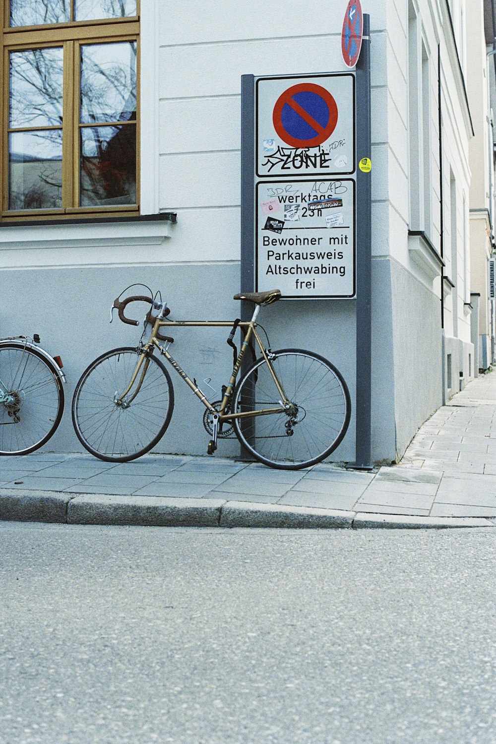 a bike parked next to a sign on the side of a building