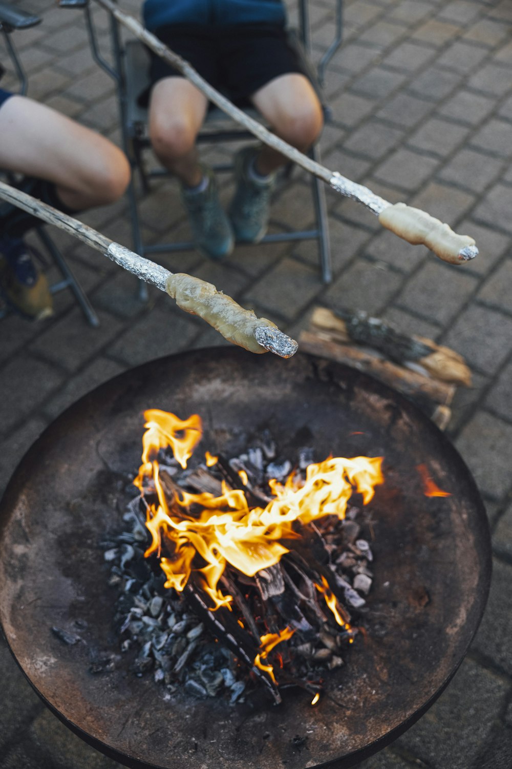 a person sitting in a chair next to a fire pit