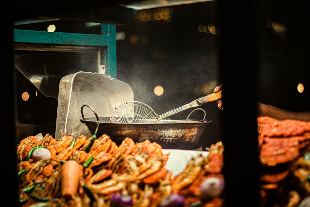 a pan of food is cooking on a grill