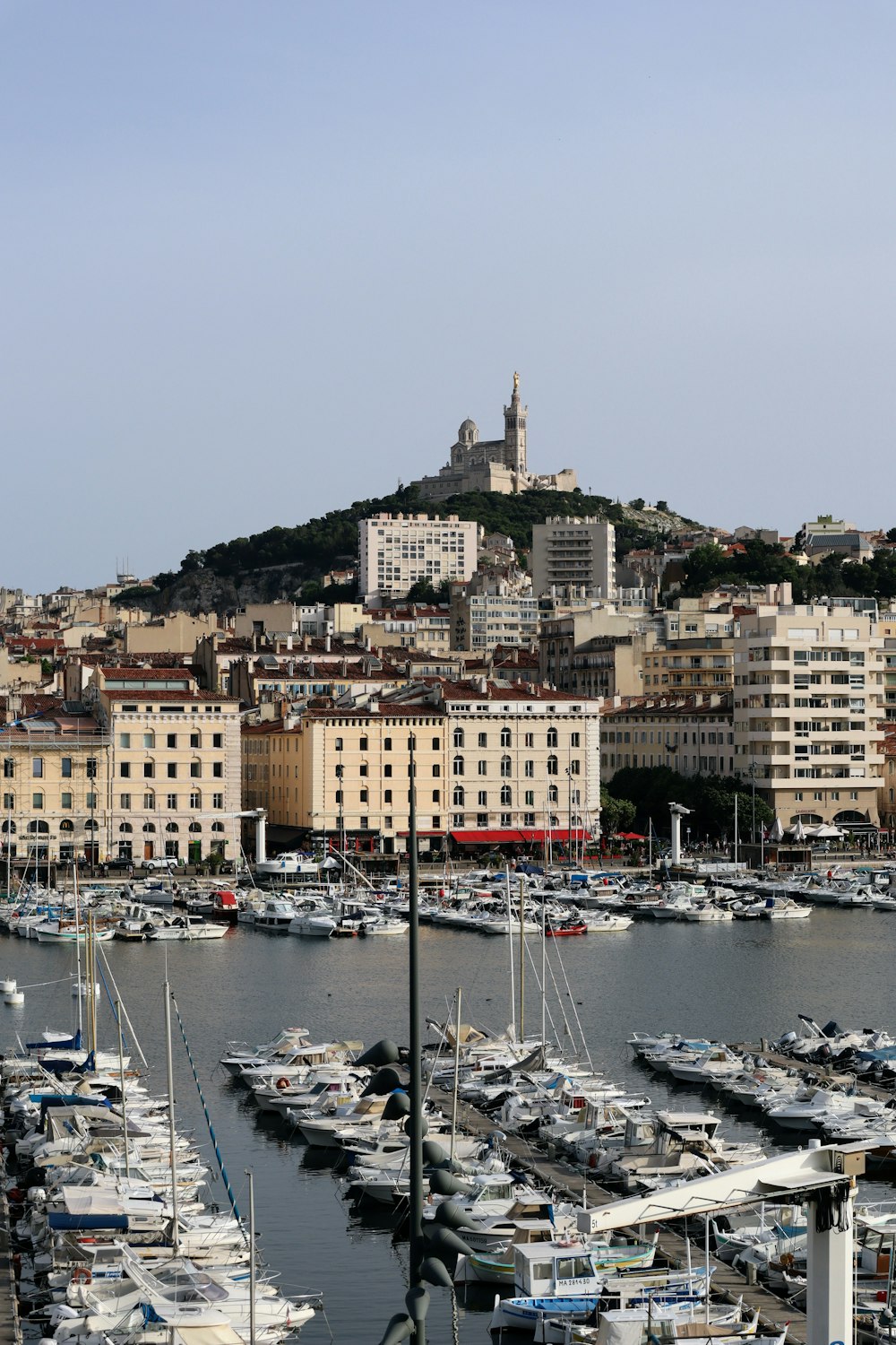 a harbor filled with lots of boats next to a city