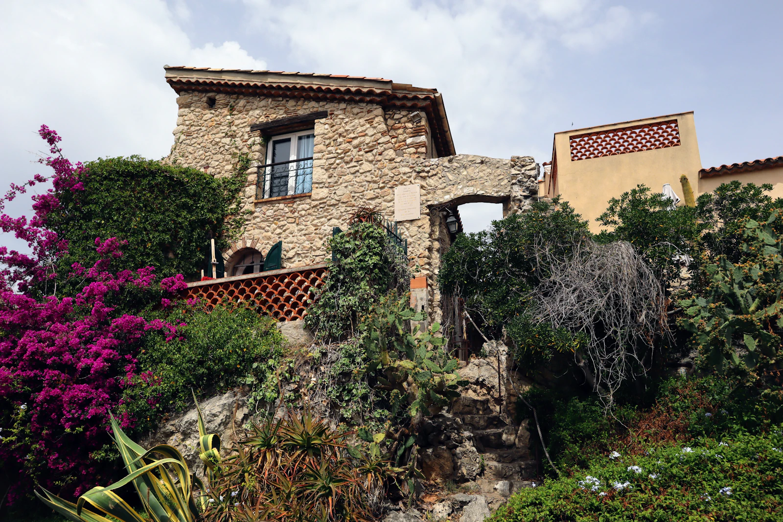 Natural stone facade of a calm, modern home with courtyard