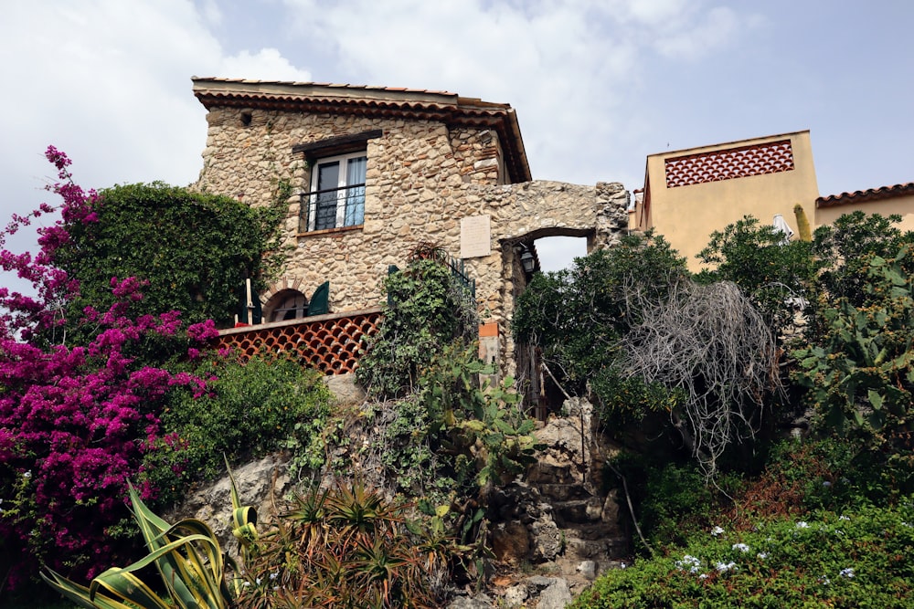 a house with a stone facade and a balcony