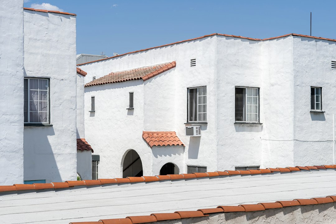 a white building with a red tiled roof