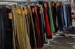 Various stylish pants and skirts arranged neatly in a boutique setting.