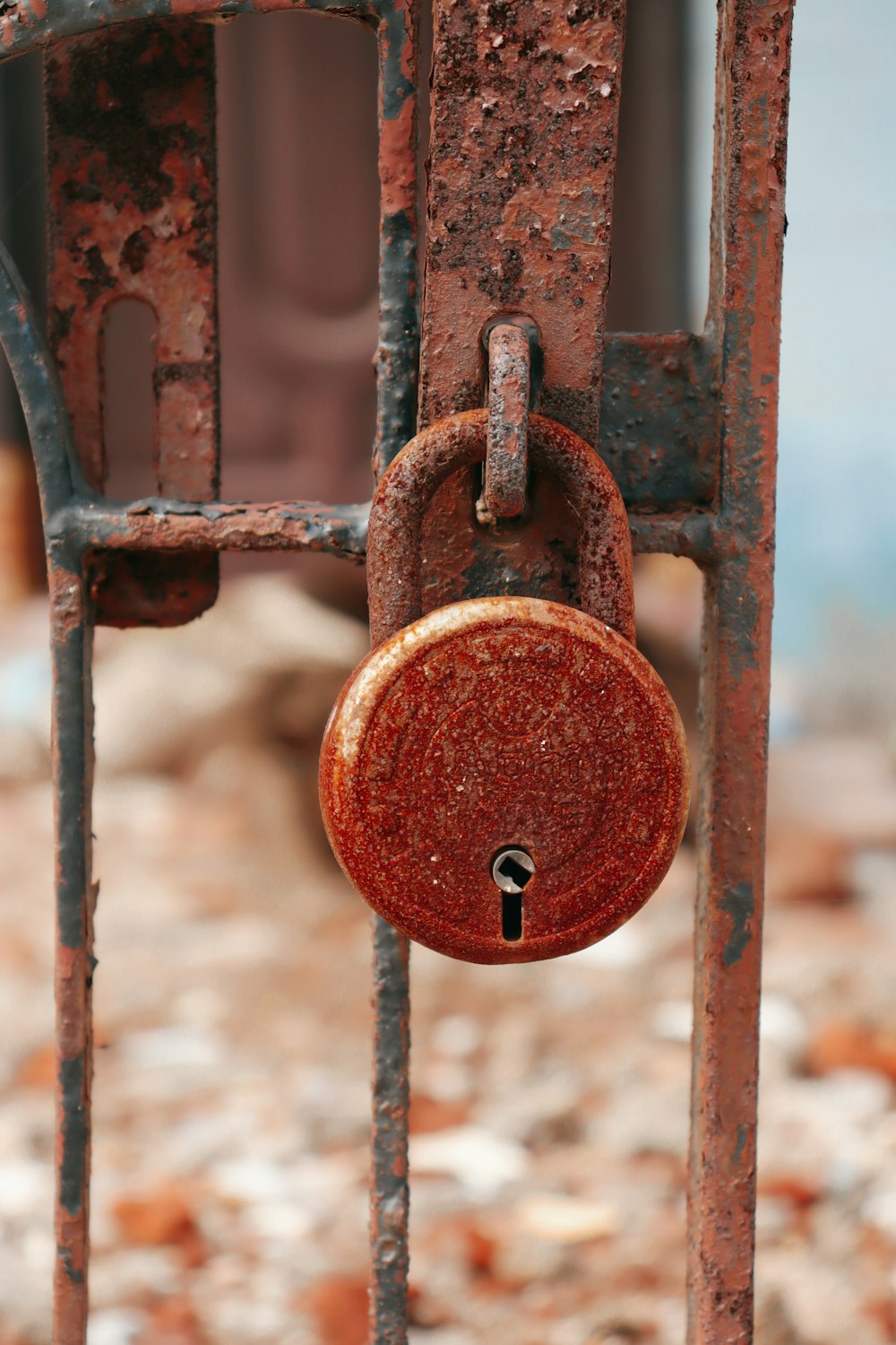a rusted gate with a padlock on it