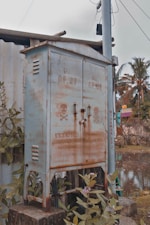 a rusted out train car sitting next to a tree