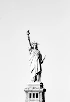 Black-and-white sample coloring page featuring the Statue of Liberty with Penny and Poppy.