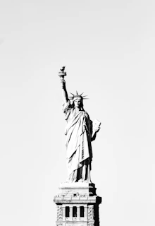 Black-and-white sample coloring page featuring the Statue of Liberty with Penny and Poppy.