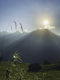 A serene landscape with a person meditating at sunrise.