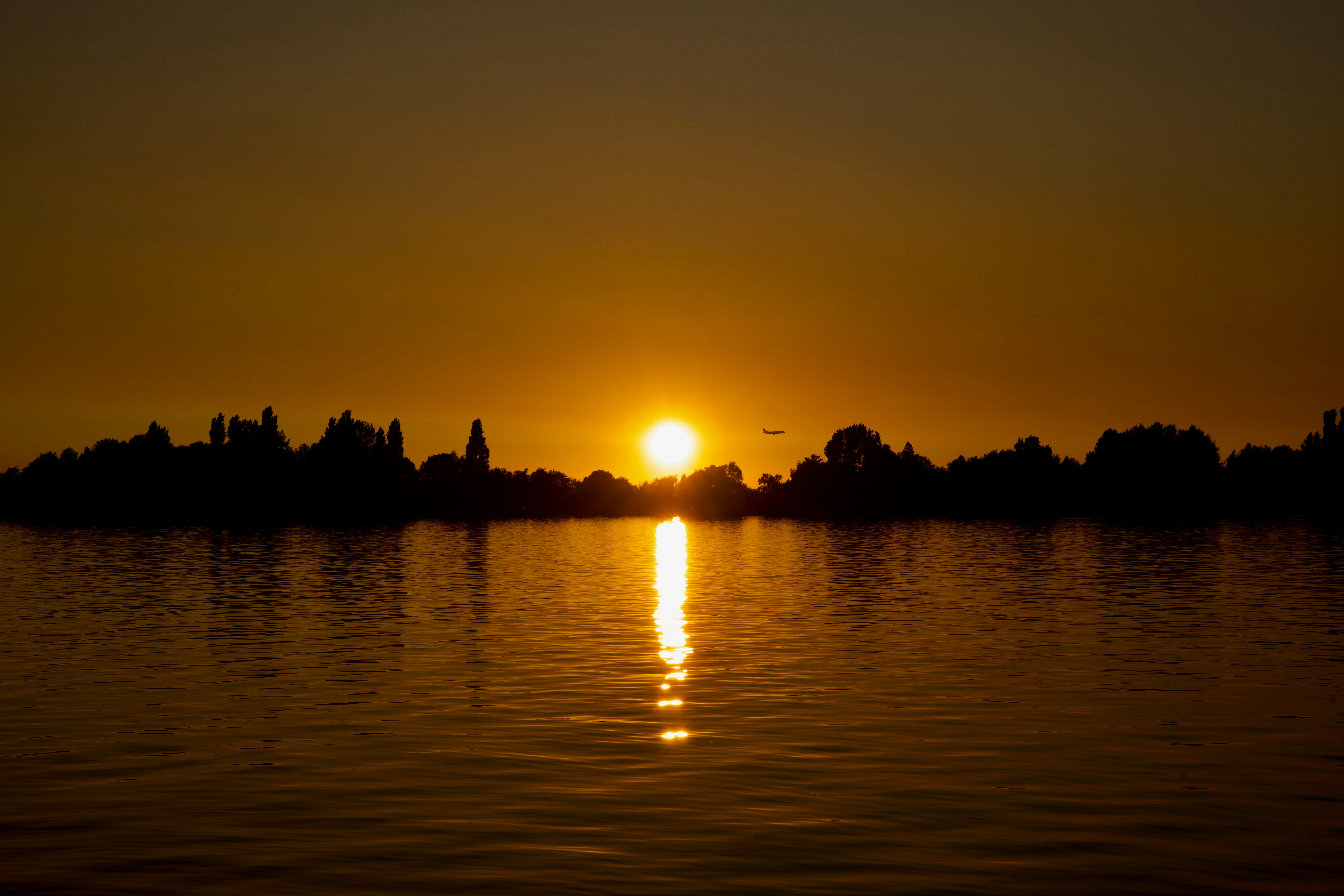 the sun is setting over a body of water