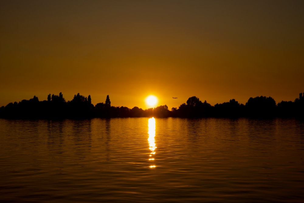 the sun is setting over a body of water