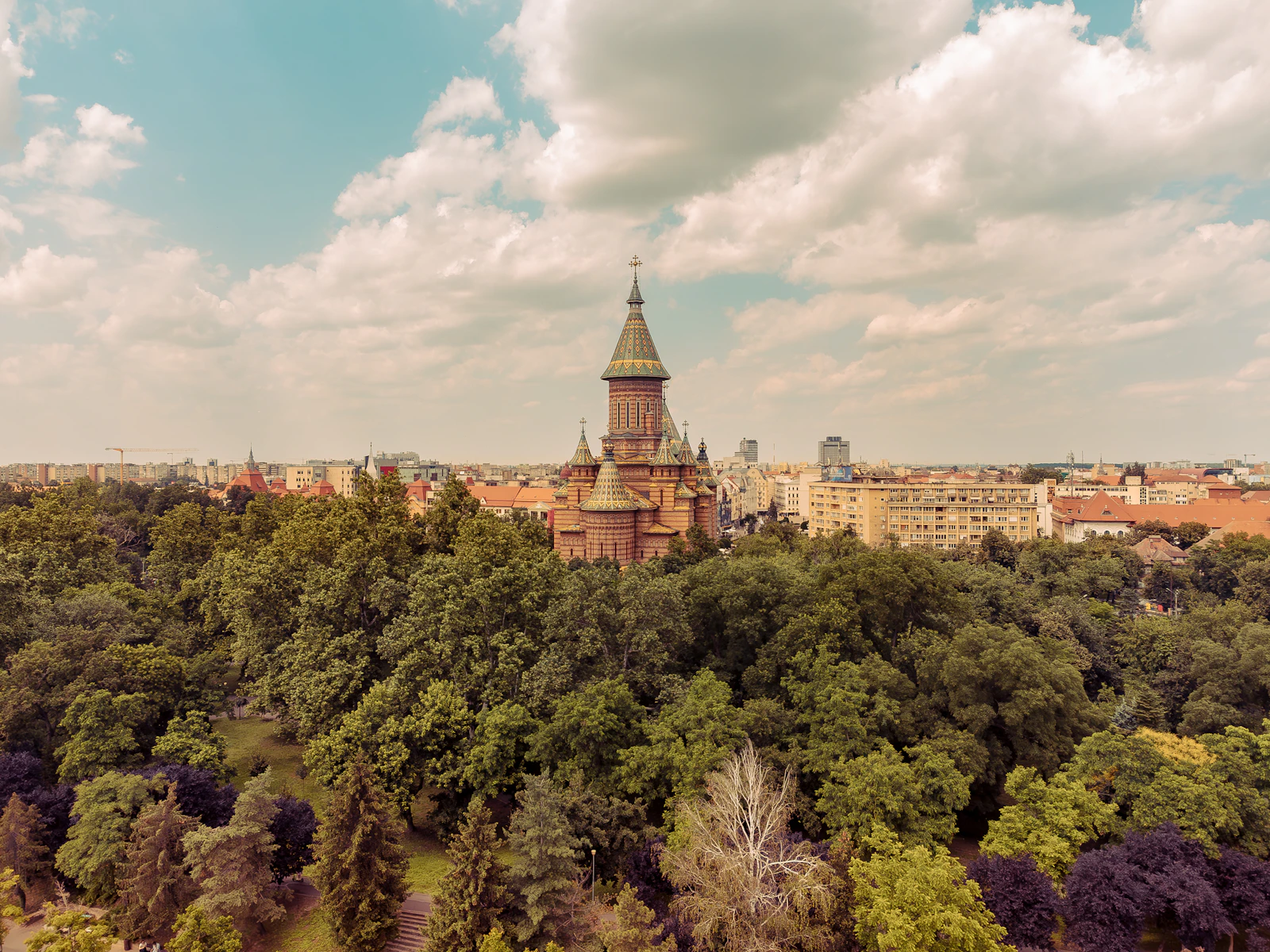 Timișoara’s Orthodox Metropolitan Cathedral rising above the park trees