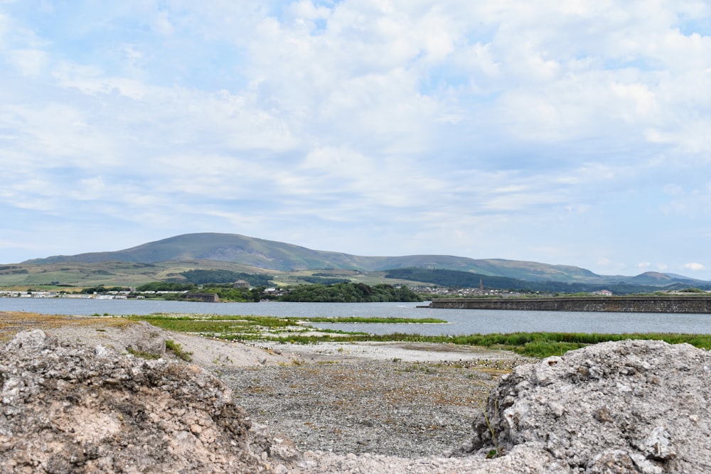 a view of a body of water with mountains in the background