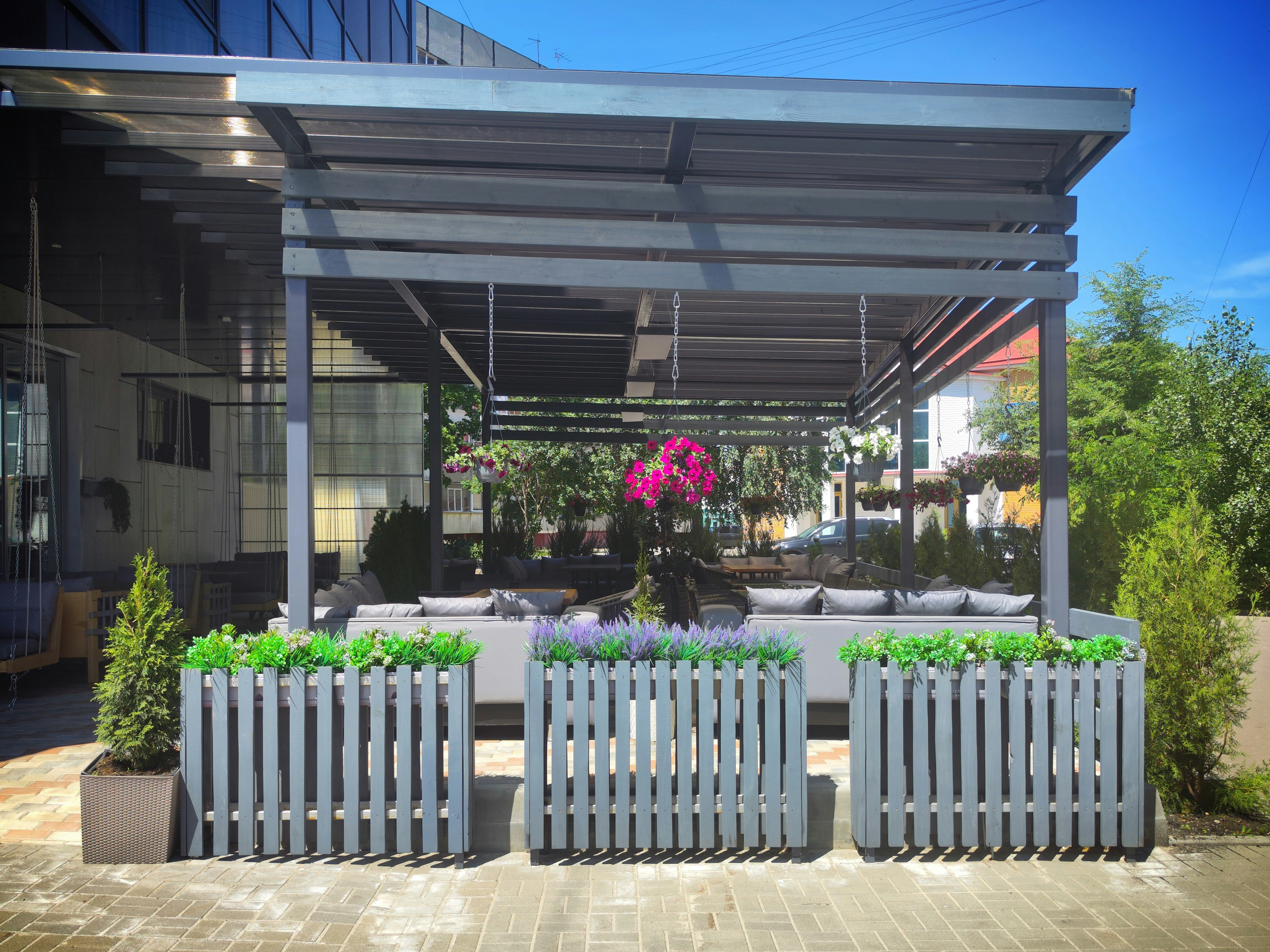 a white bench sitting under a metal roof