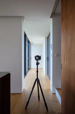 a tripod sitting on top of a hard wood floor