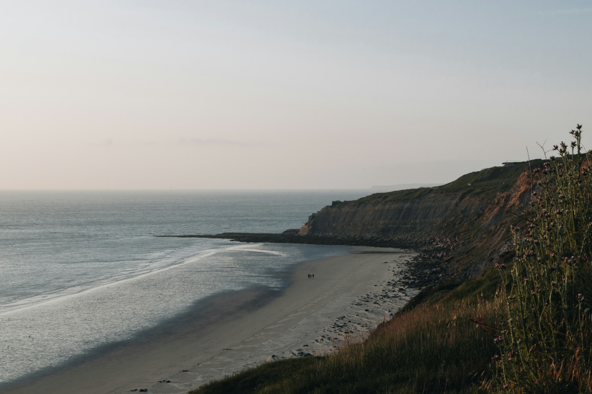 a view of a beach from a cliff
