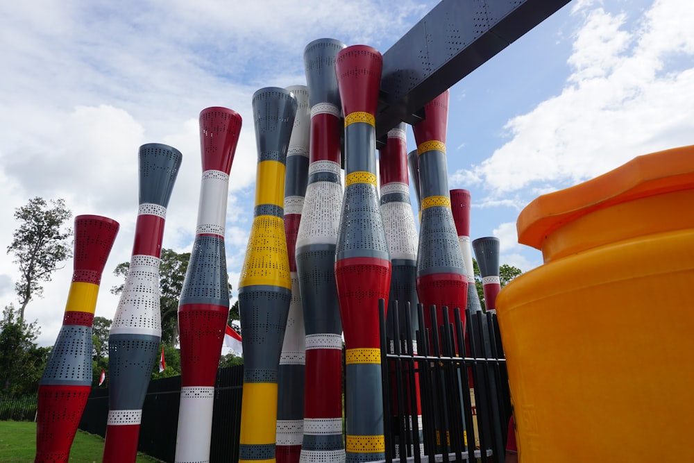 a bunch of poles that are next to a fence