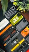 A stylish wristband and phone case set laid out on a wooden table, featuring bold colors and branding.