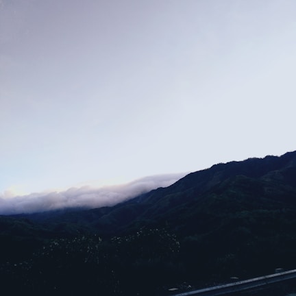 A scenic mountain slope at dawn, hinting at the setting of John's upcoming thriller.