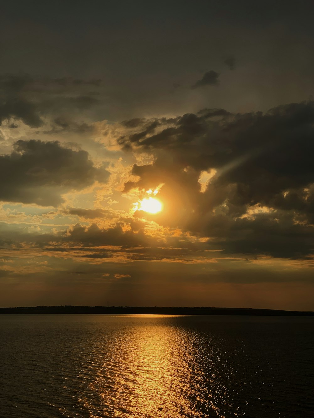 a large body of water under a cloudy sky