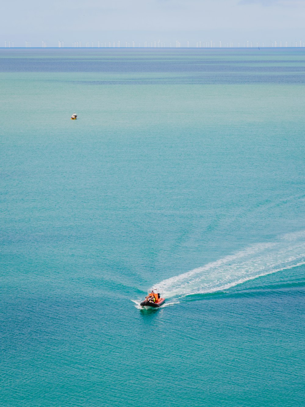 a small boat in the middle of a large body of water