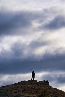 a person standing on top of a rocky hill