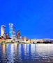 A vibrant city skyline at dusk highlighting infrastructure development.
