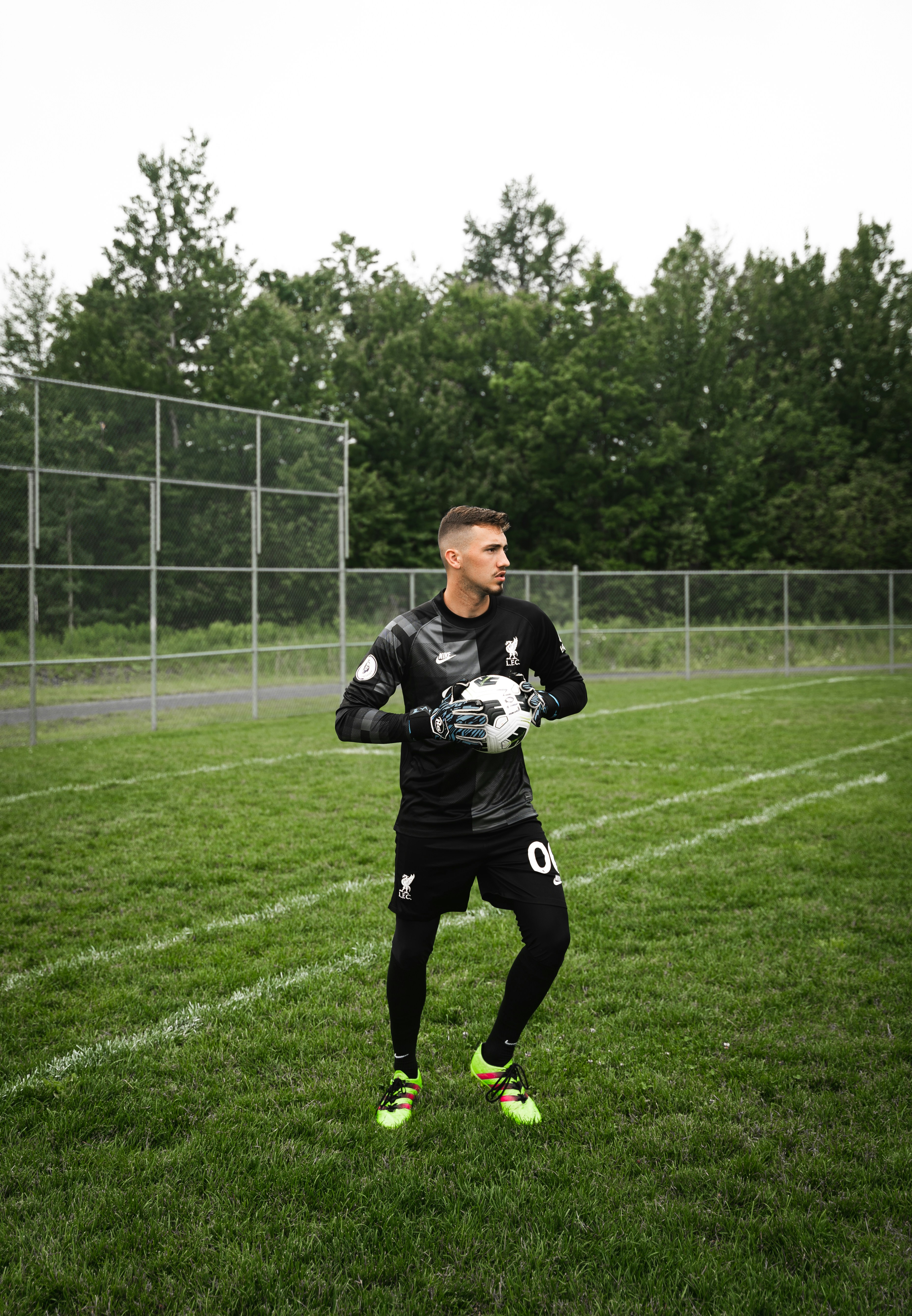 a man standing on top of a lush green field