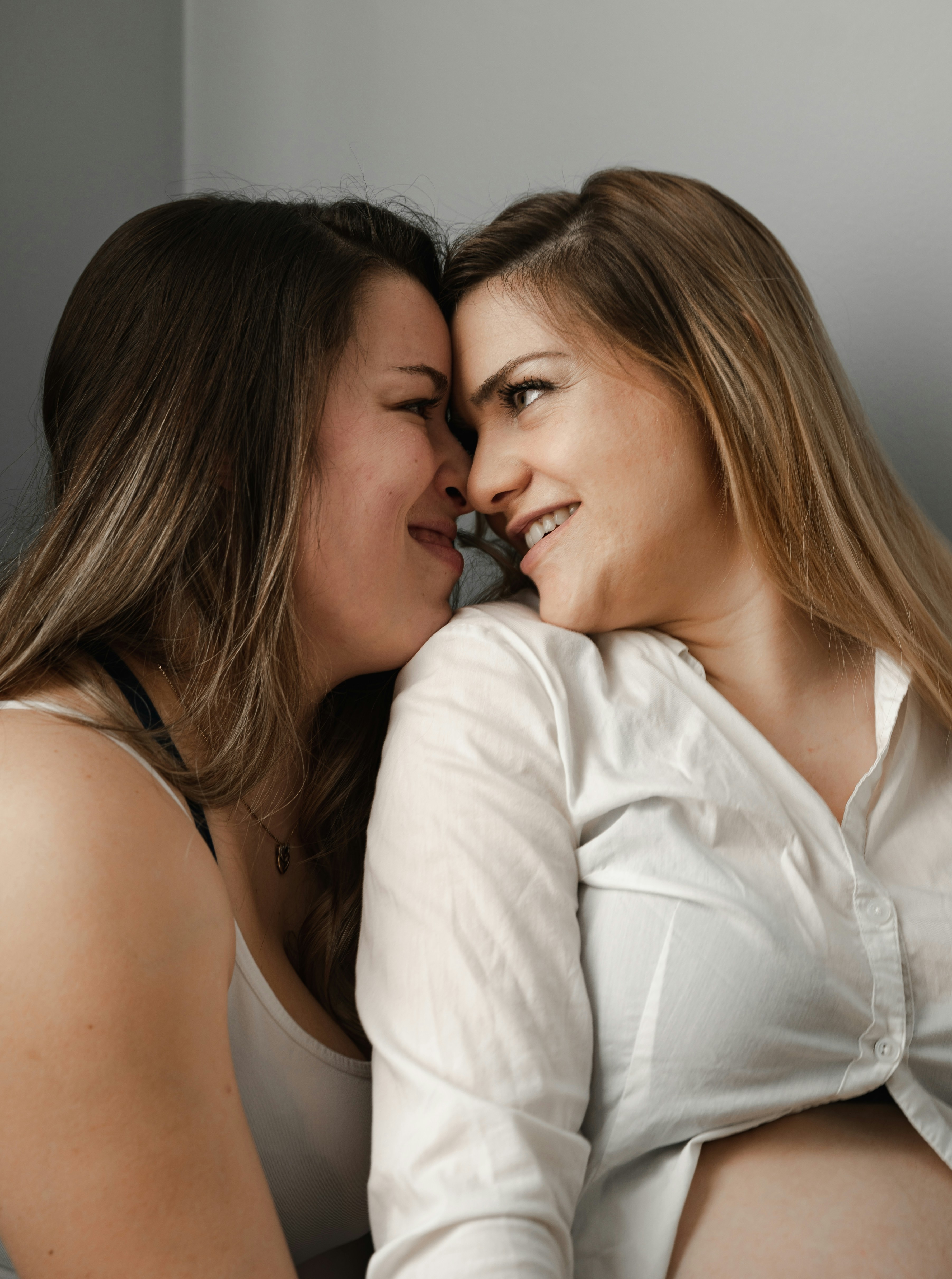 A couple of women laying next to each other photo – Free Woman Image on ...
