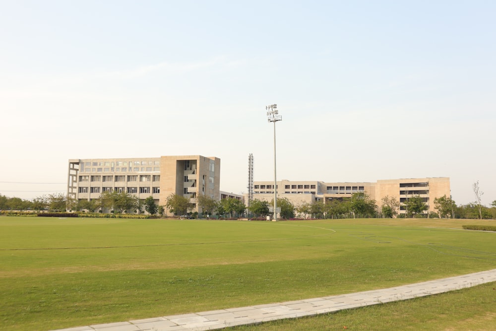 a grassy field with a building in the background