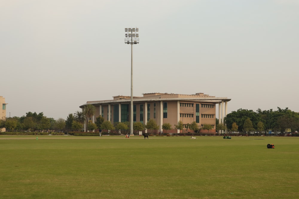 a baseball field with a large building in the background