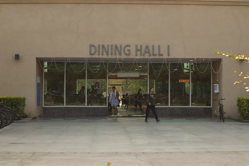a group of people walking out of a dining hall