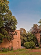 a church surrounded by trees on a sunny day