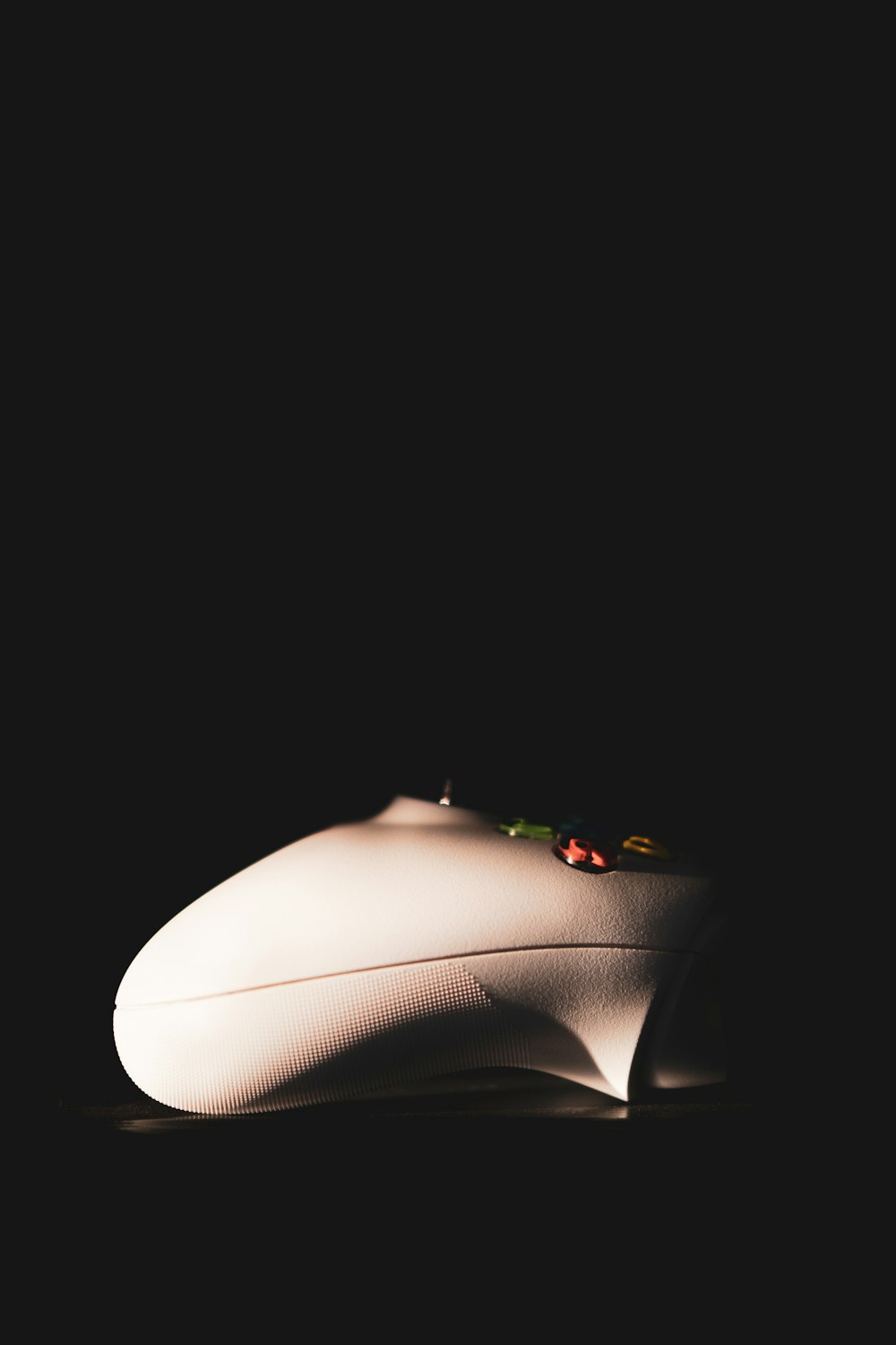 a white computer mouse sitting on top of a table