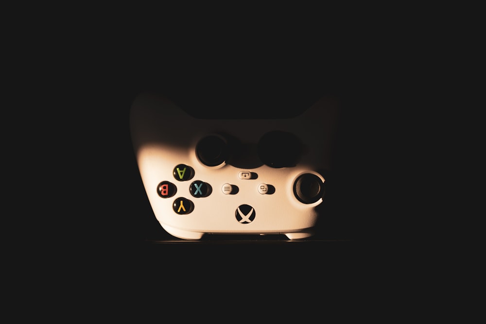 a close up of a video game controller in the dark
