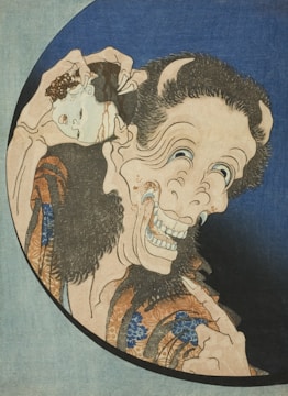 A surreal and eerie image featuring a distorted, demon-like face with exaggerated features, including bulging eyes and sharp teeth. The figure is holding a mask or face, which it appears to be removing or putting on. The artwork has traditional Japanese elements, with intricate patterns on the clothing and a dark, unsettling expression on the face.