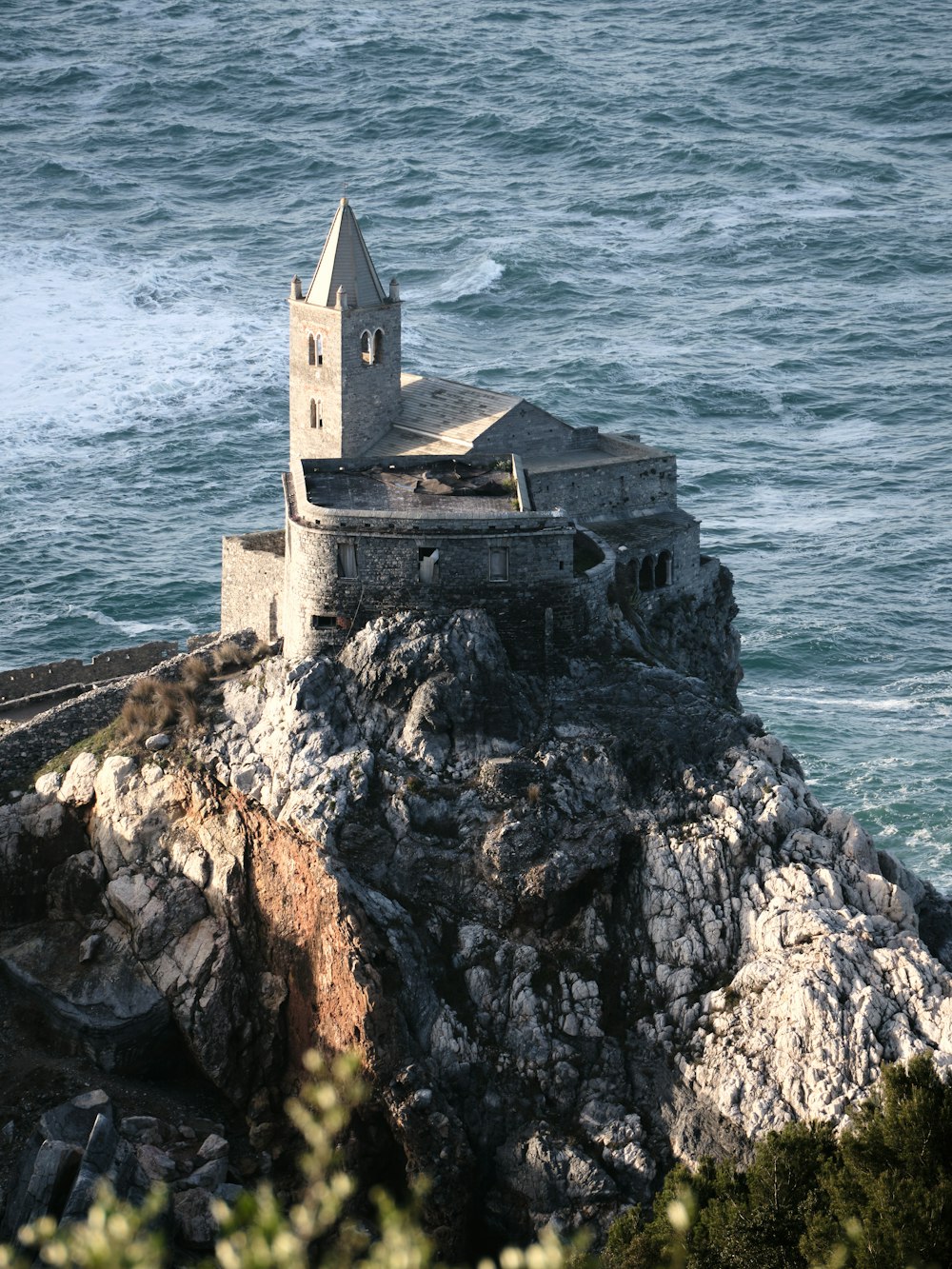 an old church on a rocky outcropping by the ocean