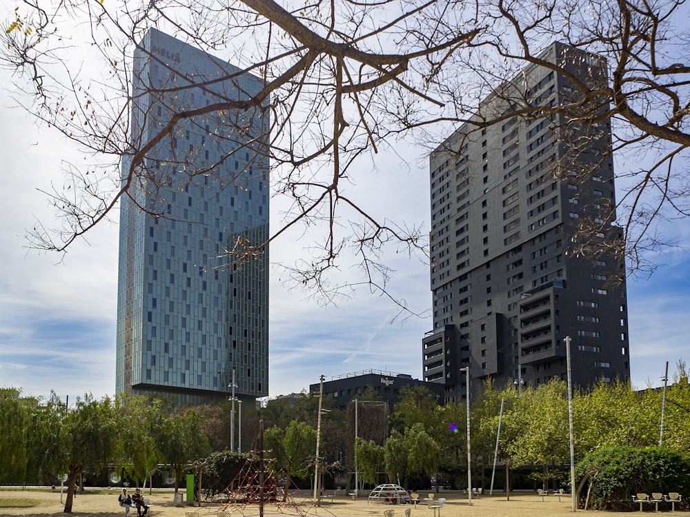 a couple of tall buildings sitting next to each other