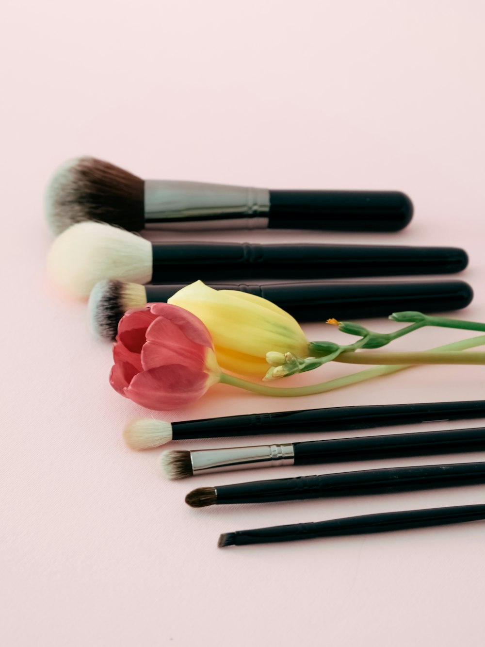 a bunch of makeup brushes sitting on top of a table