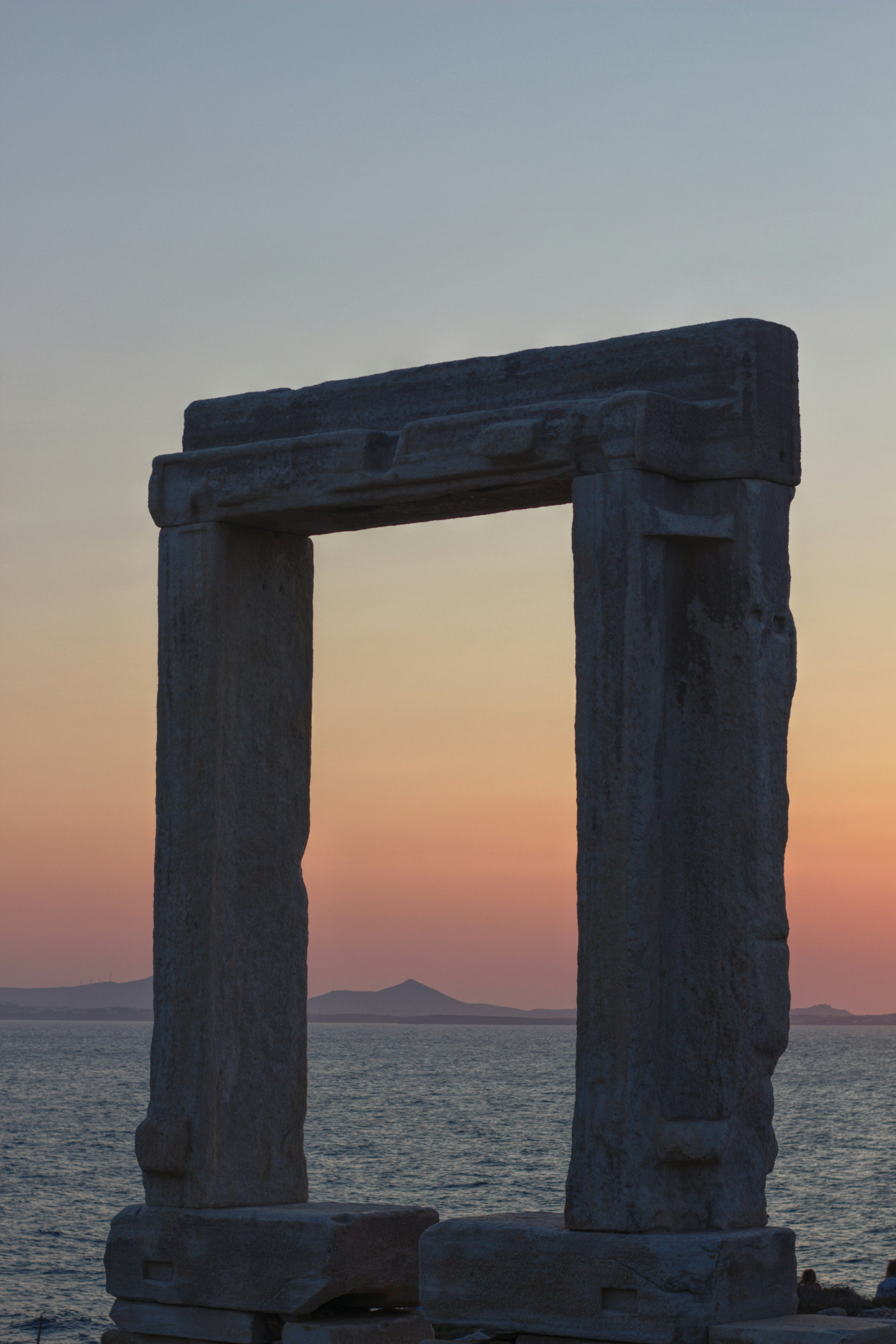 a stone structure sitting on top of a beach next to the ocean