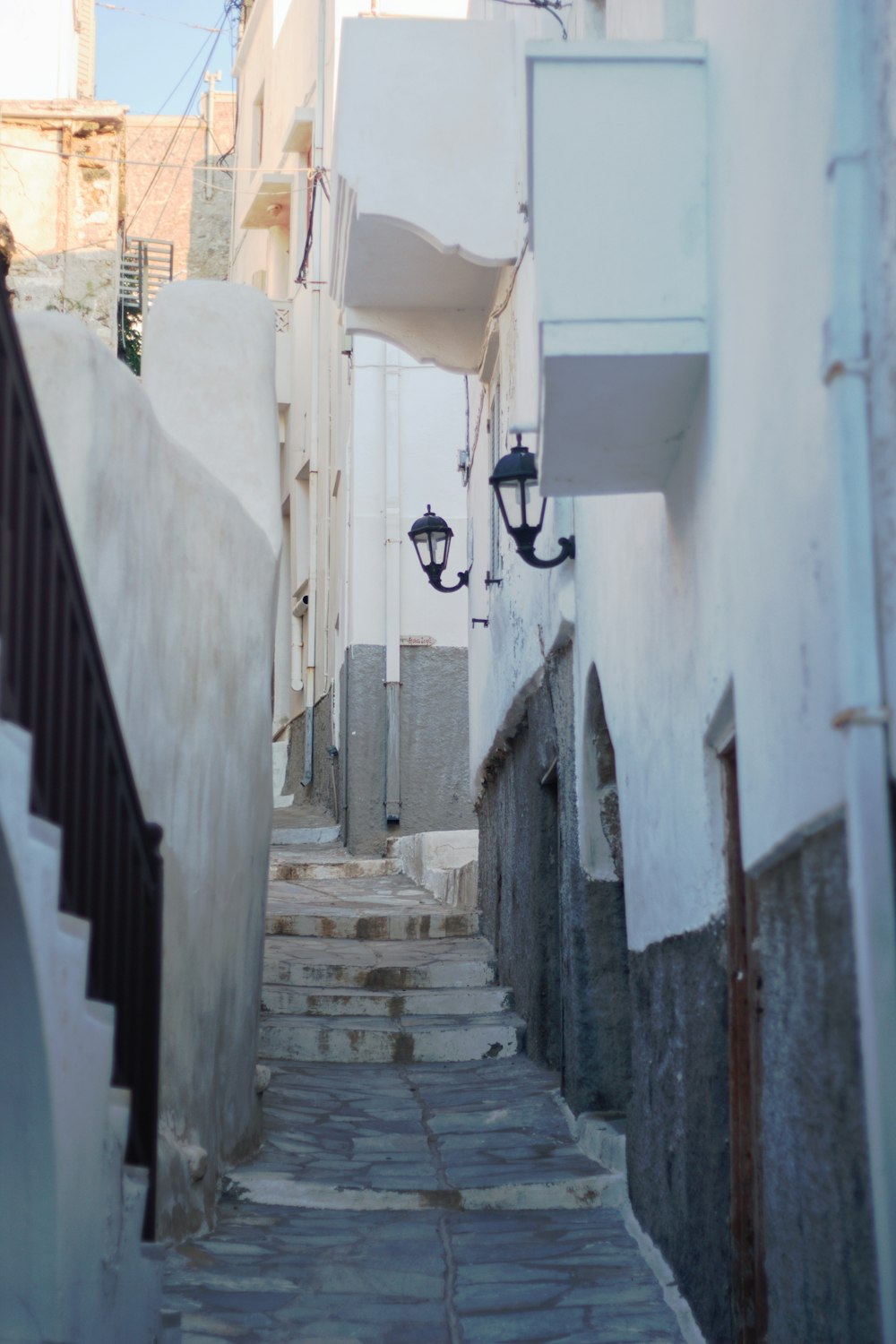 a narrow street with steps leading up to a building