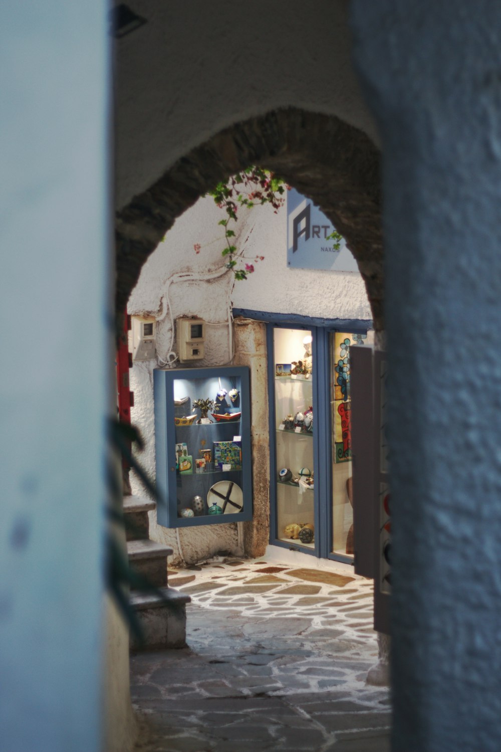 a narrow alley way with a store front