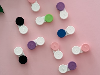 A collection of colorful contact lens boxes arranged on a shelf.