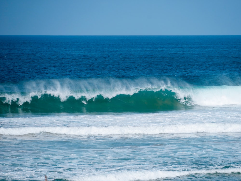 a person riding a surfboard on a wave in the ocean