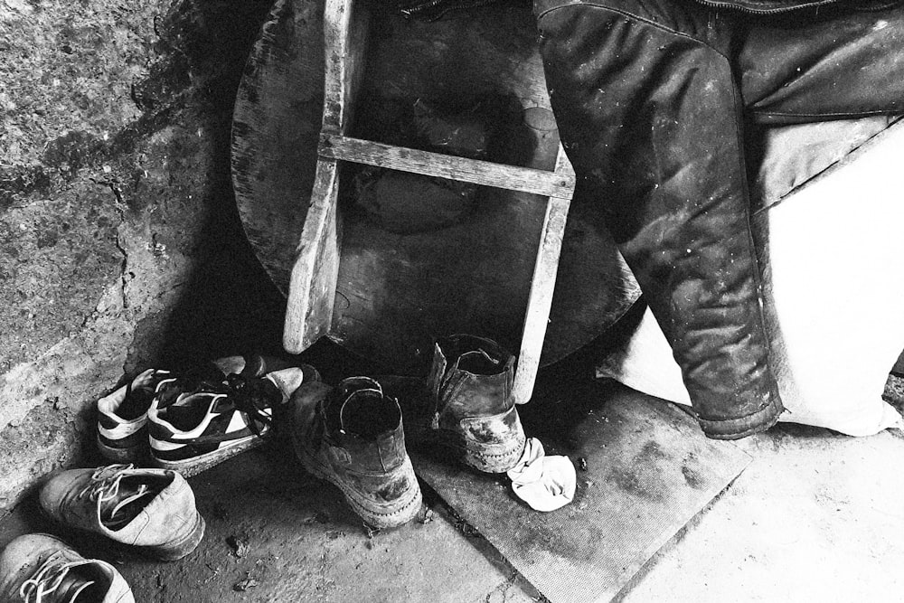 a black and white photo of shoes and a chair