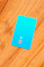 a blue sim card sitting on top of a wooden table