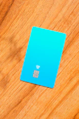 a blue sim card sitting on top of a wooden table