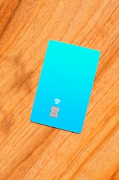 a blue sim card sitting on top of a wooden table