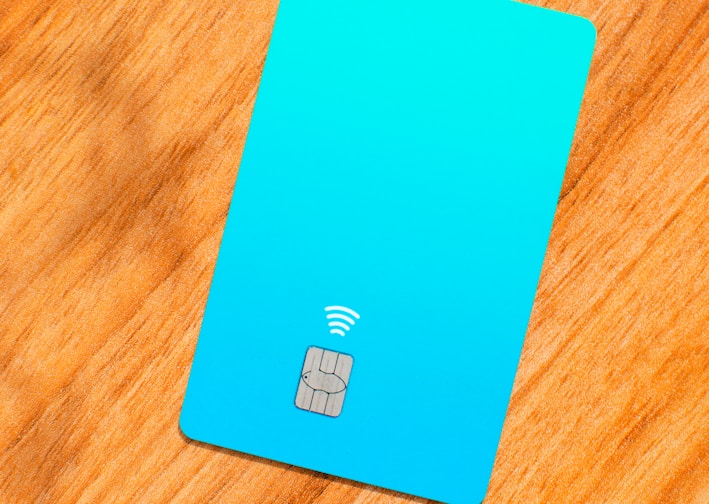 a blue sim card sitting on top of a wooden table